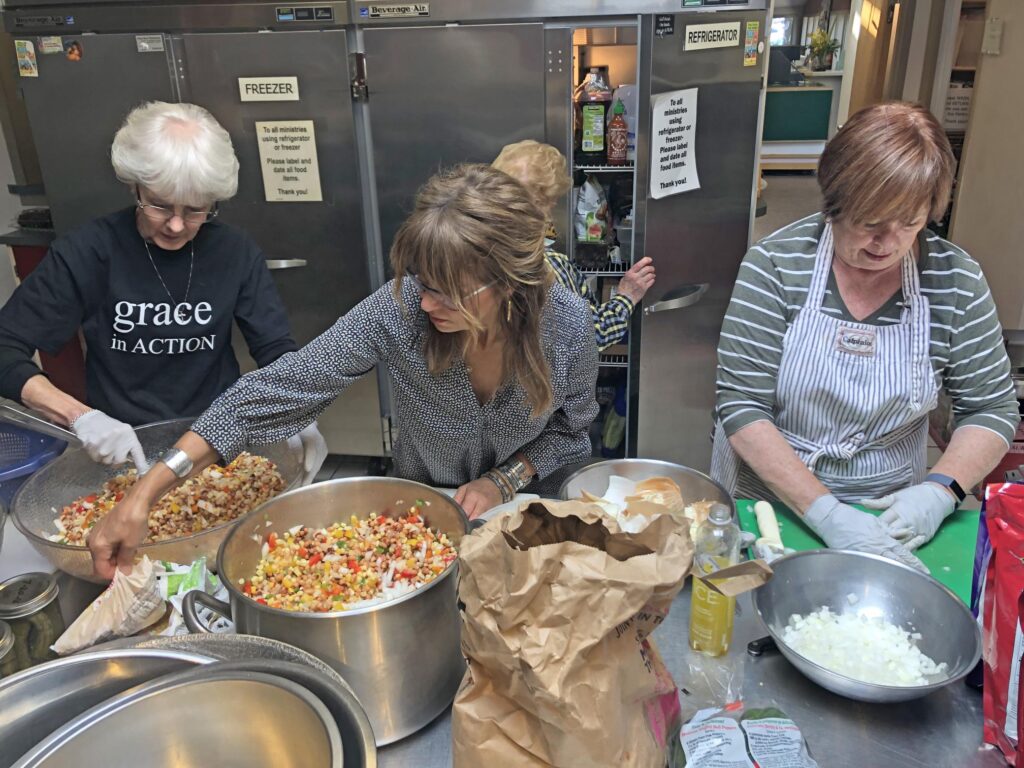 Volunteers preparing food through Grace in Action's food ministry