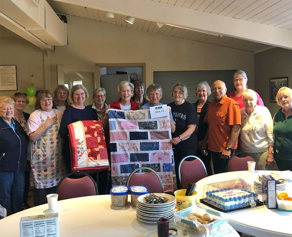 Members quilting together for outreach donations